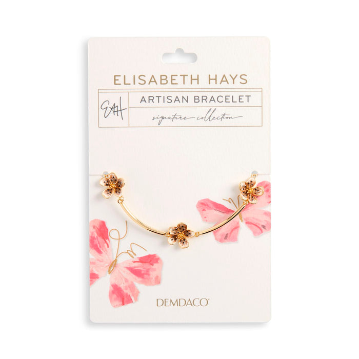 Gold bracelet with pink flowers on a white card featuring 'Elisabeth Hays' branding.