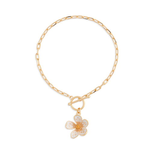 Gold bracelet with a floral charm on a white background