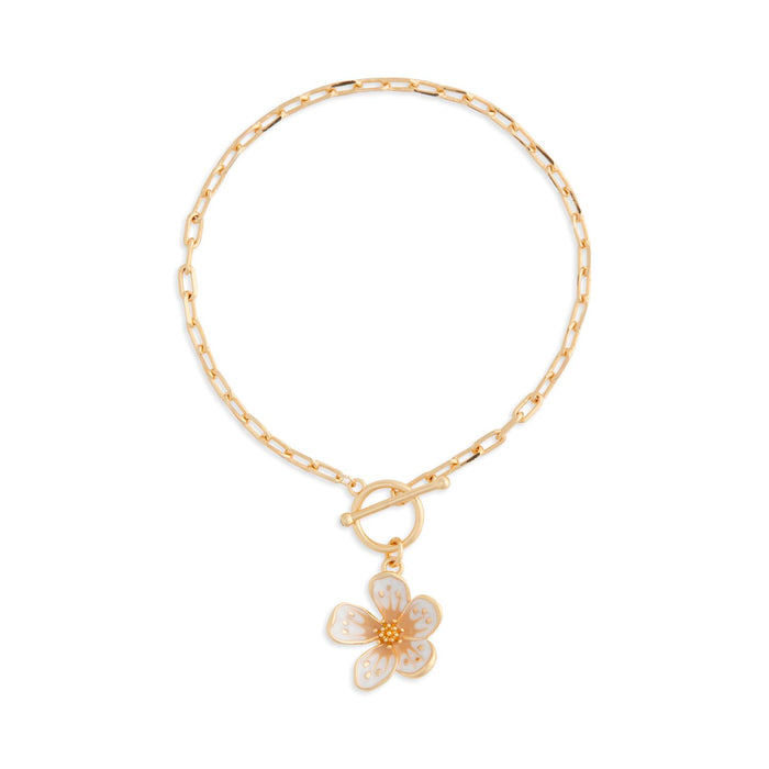 Gold bracelet with a floral charm on a white background