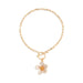Gold bracelet with a floral charm on a white background