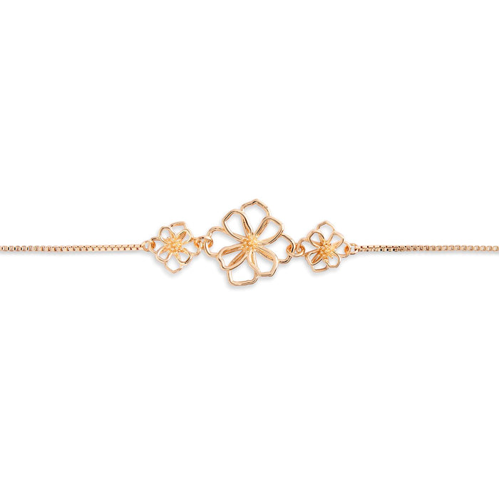 Gold bracelet with floral designs on a white background