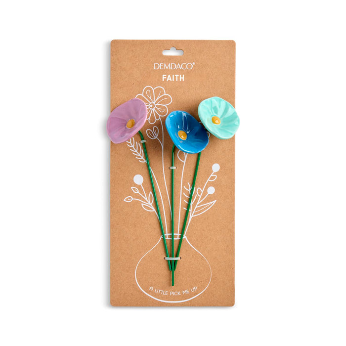 Packaged flower-shaped pins with 'Demdaco Faith' branding on a white background