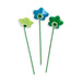 Three decorative flowers on green stems against a white background