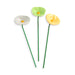 Three ceramic flower-shaped planters in green, yellow, and white on a white background