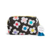 A rectangular cosmetic pouch with a black background and a white daisy pattern featuring colorful flower centers. It has a gold zipper, a blue tassel, and a white circular tag that reads 'DE'MEACO x Charmander'.