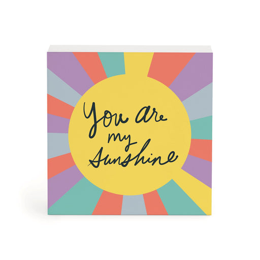 A square decorative block or plaque with a colorful sunburst design and the phrase 'You are my Sunshine' in black script on a yellow center circle, shown on a white background.