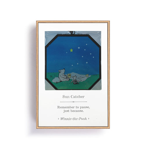 Framed artwork with a cartoon scene of two bears under a starry sky, featuring a quote from Winnie the Pooh.