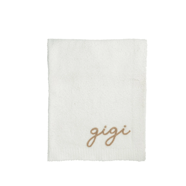 White towel with 'gigi' embroidery on a white background
