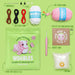 Wobbles crochet kit with yarn, needle, eyes, and other supplies on a green background