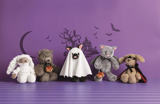 Five teddy bears dressed in Halloween costumes on a purple background with a haunted house and moon.