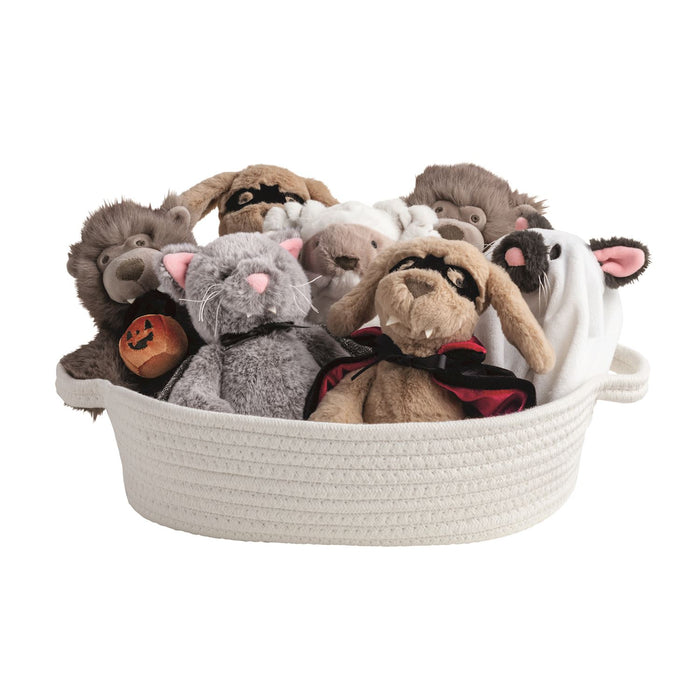 Basket filled with plush toys including rabbits and a bear on a white background