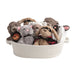 Basket filled with plush toys including rabbits and a bear on a white background