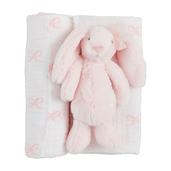 Pink plush bunny toy and blanket with butterfly pattern on a white background