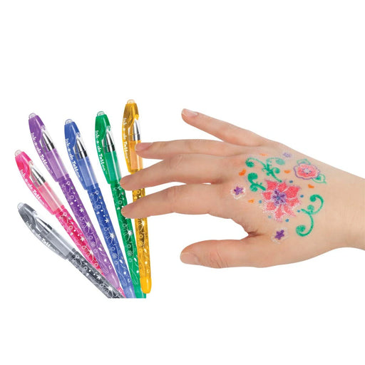 Colorful tattoo pens with a hand displaying floral tattoos on a white background