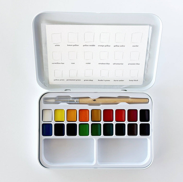 Watercolor paint set with color swatches and a brush on a white background
