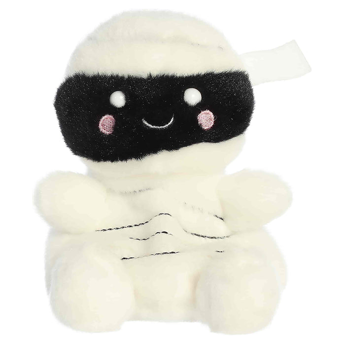 Plush toy resembling a mummy with a happy expression on a white background