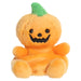 Plush toy pumpkin with a smiling face on a white background