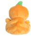 Plush toy shaped like a pumpkin with a green stem on a white background