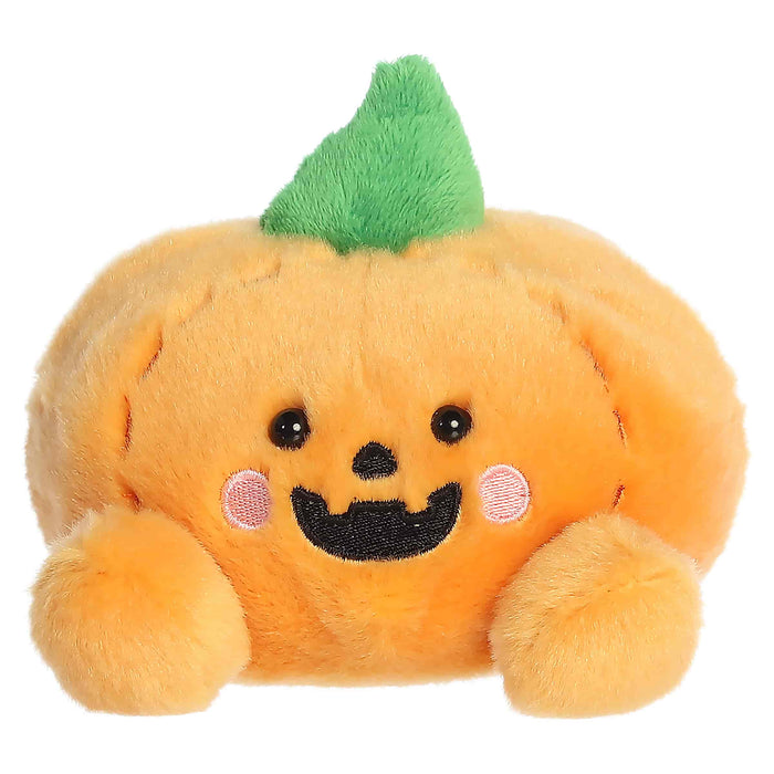 Plush toy pumpkin with a smiling face on a white background