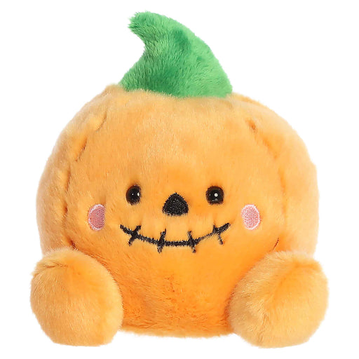 Plush toy pumpkin with a face on a white background