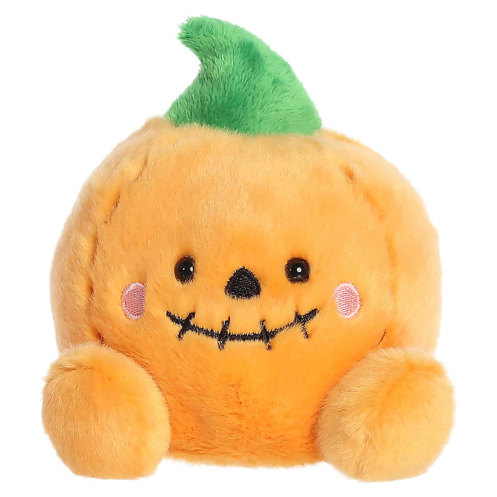 Plush toy pumpkin with a face on a white background