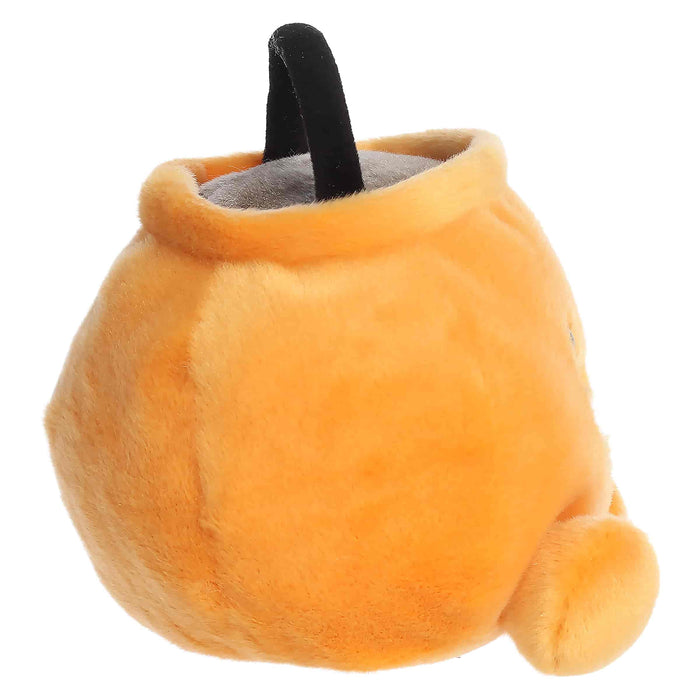 Plush pumpkin toy with a black handle on a white background