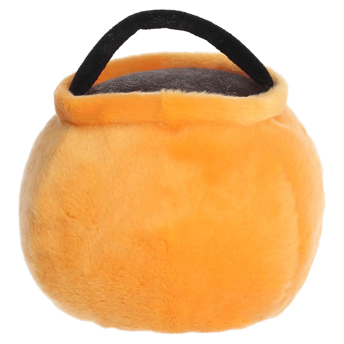 Orange plush toy with a black handle on a white background