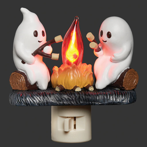 Two ghost night lights around a campfire on a black background