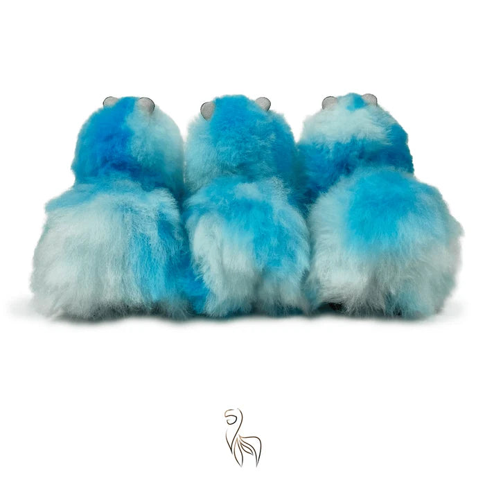 Three fluffy blue and white gradient plush toys with small gray eyes, shown from the back against a white background.