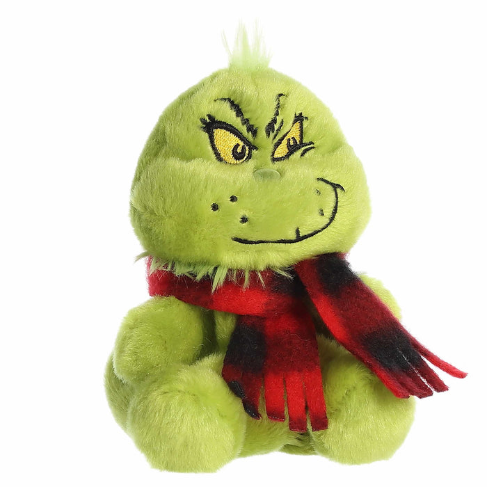 Green plush toy with a red scarf on a white background