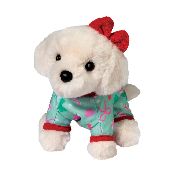 Plush toy dog wearing a red bow and pajamas with heart patterns on a white background