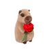 Plush toy guinea pig holding a red rose on a white background