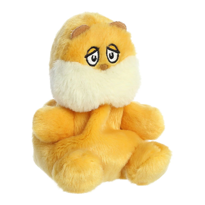 Plush toy resembling a yellow character with a white muzzle on a white background