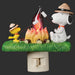 Snoopy and Woodstock around a campfire with marshmallows, night light on a black background