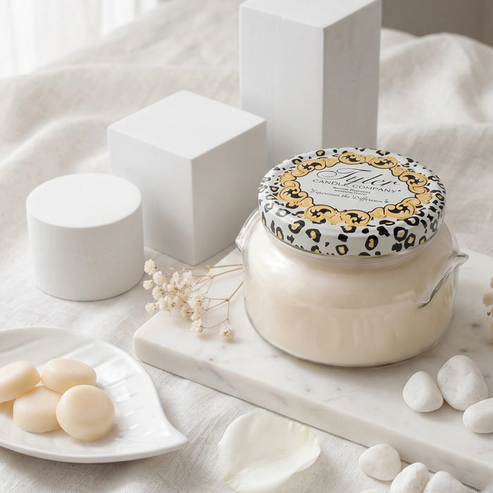 Decorative candle with leopard print packaging on a marble surface with a neutral background