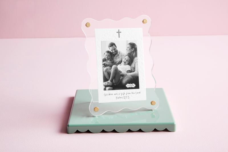 Small photo frame with a family photo on a pink background