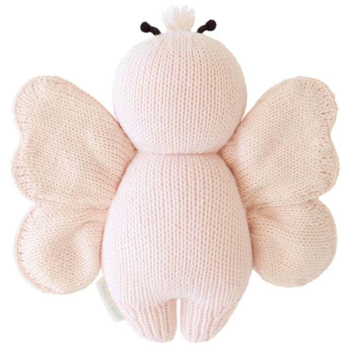 Knitted butterfly toy with a white body and pink wings on a white background