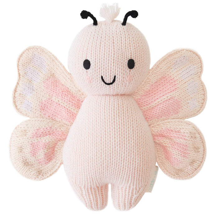 Knitted butterfly toy with pink and white wings on a white background
