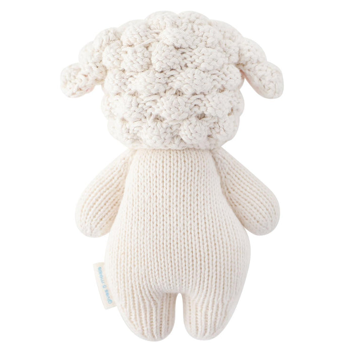 Knitted sheep toy on a white background