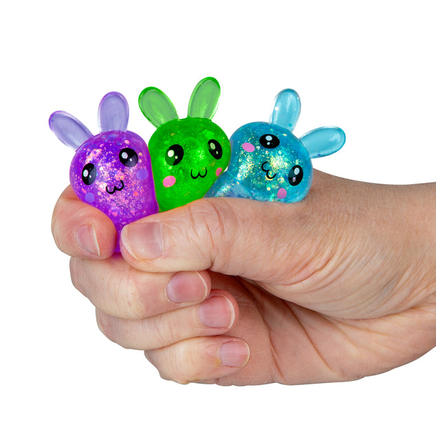 Three colorful finger puppets held in a hand against a white background