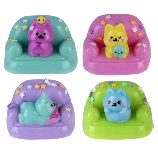 Four assorted Taba-Licious Couch Potato puppy squish toys on purple, pink, blue, and green couches
