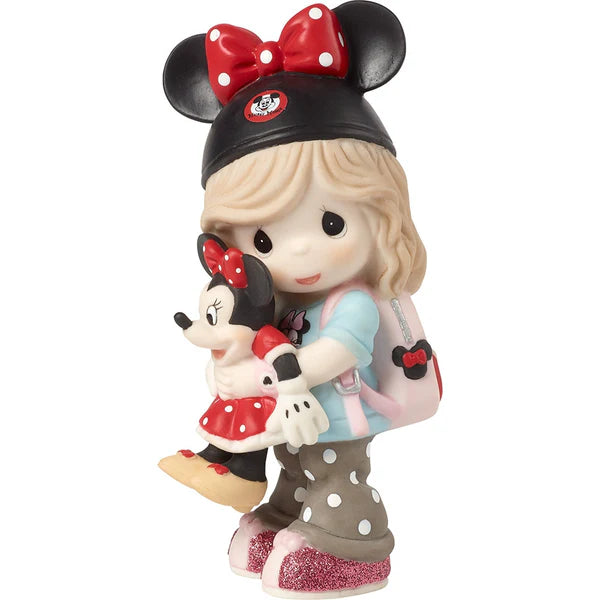 A Precious Moments collectible figurine of a girl with blonde hair wearing a black Minnie Mouse hat and holding a small Minnie Mouse doll, set against a plain white background.