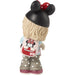A Disney Minnie Mouse figurine shown from the back, wearing a black Minnie Mouse hat with a red bow, a light blue top, a pink backpack with Minnie Mouse graphics, gray polka-dot pants, and glittery pink shoes, on a white background.