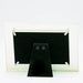 Black owl earrings on a stand with a clear acrylic display case on a white background