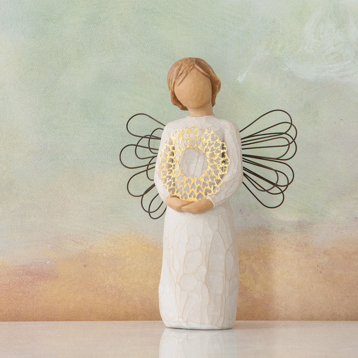 Standing angel in cream dress and wire wings, holding thin, pierced-metal, gold-leafed wreath of hearts