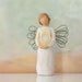 Standing angel in cream dress and wire wings, holding thin, pierced-metal, gold-leafed wreath of hearts