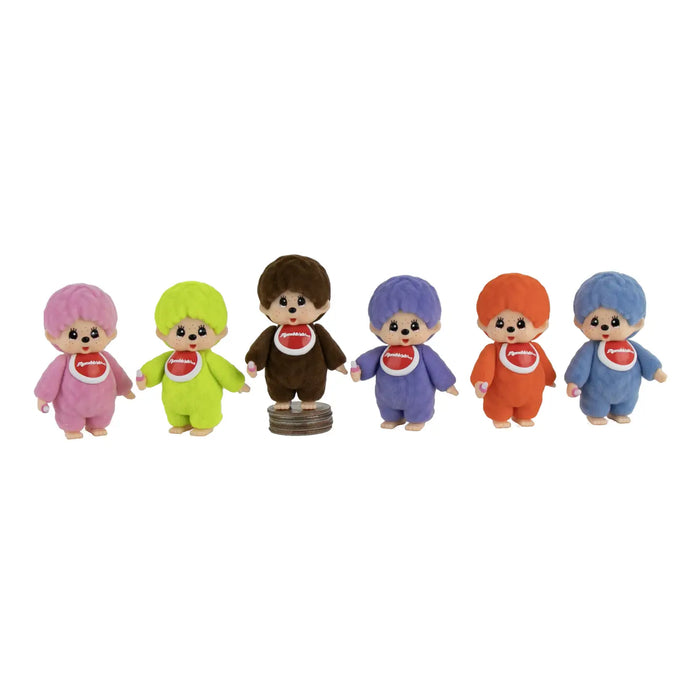 Six small plush toy figures standing in a row on a plain white background. Each figure has a round head, large dark eyes, and wears a solid-colored outfit with a red-and-white bib.