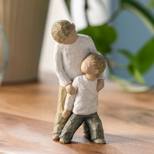 Figure of two boys, younger leaning against the older