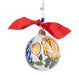 Decorative ornament with floral design and red ribbon on a white background