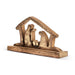 A wooden nativity scene figurine featuring Mary, Joseph, and baby Jesus under a stable roof, mounted on a rectangular wooden base, shown against a plain white background.